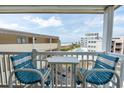 Inviting balcony features seating and scenic views of the ocean and nearby pool at 9620 Shore Dr. # 307, Myrtle Beach, SC 29572