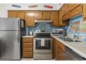 Well-equipped kitchen with wooden cabinets, stainless steel appliances, and neutral countertops at 9620 Shore Dr. # 307, Myrtle Beach, SC 29572