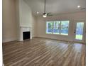 Bright living room with fireplace, high ceiling, and luxury vinyl flooring at 974 Crooked Oak Dr., Pawleys Island, SC 29585