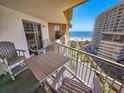Condo balcony with nice chairs and table overlooking the beach and ocean at 9994 Beach Club Dr. # 706, Myrtle Beach, SC 29572