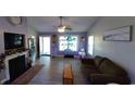 Inviting living room featuring hardwood floors, a fireplace, and plenty of natural light at 1210 Horry Rd., Aynor, SC 29511