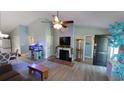 Bright living room with a fireplace, ceiling fan, and views into the dining area at 1210 Horry Rd., Aynor, SC 29511