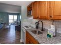 The kitchen has white appliances, wood cabinets and a granite countertop at 2001 S Ocean Blvd. # 207, Myrtle Beach, SC 29577