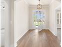Bright foyer featuring hardwood floors and a glass front door at 348 Autumn Pheasant Loop, Calabash, NC 28467