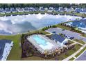 Enjoy this aerial view of the community pool, amenity center, and scenic pond at 402 Bumble Circle, Murrells Inlet, SC 29576