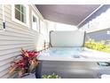 Backyard hot tub featuring retractable awning and exterior wall detailing at 402 Bumble Circle, Murrells Inlet, SC 29576