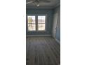Bedroom featuring hardwood floors, blue walls, and a window with a neighborhood view at 4831 Riverside Dr., North Myrtle Beach, SC 29582