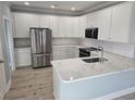 Modern kitchen with white cabinets, stainless steel appliances, and quartz countertops at 4831 Riverside Dr., North Myrtle Beach, SC 29582