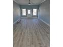 Bright living room with light blue walls, fan, and wood-look flooring at 4831 Riverside Dr., North Myrtle Beach, SC 29582