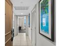 Inviting hallway with beach views through the living room featuring colorful artwork and modern decor at 107 S Ocean Blvd. # 1201, Myrtle Beach, SC 29577