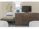 Well-appointed bedroom includes a TV and a bench for additional comfort at 1105 S Ocean Blvd. # 422, Myrtle Beach, SC 29577
