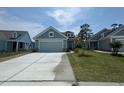 Lovely one-story home with a two-car garage, freshly poured driveway, and a well-maintained lawn at 1233 Lady Bird Way, North Myrtle Beach, SC 29582