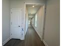 Long hallway featuring recessed lighting, neutral walls, and modern wood-look flooring at 1233 Lady Bird Way, North Myrtle Beach, SC 29582