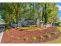 Allston community entrance sign surrounded by lush landscaping, brick accents, and mature trees at 141 Wickham Ct., Pawleys Island, SC 29585