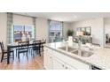 Open-concept kitchen with granite countertops, view of the lake, and natural light at 1419 Nokota Dr., Conway, SC 29526