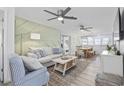 Inviting living room featuring stylish decor, comfortable seating, ceiling fans, and a view to the dining area at 1512 S Ocean Blvd., North Myrtle Beach, SC 29582