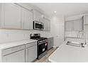Modern kitchen showcasing stainless steel appliances, white countertops, and gray cabinetry at 1513 Anne St., North Myrtle Beach, SC 29582