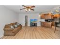 Open living room with wood floors, ceiling fan and ample natural light flowing into the kitchen at 1801 N Ocean Blvd. # A4, North Myrtle Beach, SC 29582
