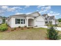 A lovely single-story home featuring a manicured lawn and attached two-car garage at 1804 Hardwood Ct., Conway, SC 29526