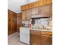 Kitchen featuring wood paneling, wood cabinets, white appliances, and vinyl floors at 191 Maison Dr. # B-319, Myrtle Beach, SC 29572