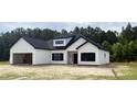 Beautiful exterior of newly constructed white home with dark trim and a garage at 204 Shady Pines Ct., Conway, SC 29527