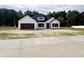 Charming new construction with a modern farmhouse design, black windows, and an attached two-car garage at 204 Shady Pines Ct., Conway, SC 29527