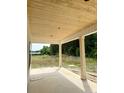 View of patio with wood-paneled ceiling, columns, and concrete flooring, showing a beautiful outdoor living space at 204 Shady Pines Ct., Conway, SC 29527