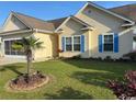 Well-maintained front yard with a palm tree accenting the facade of this lovely home at 213 Cupola Dr., Longs, SC 29568