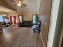 Living room with hardwood floors, an open layout, leather sofa, and a large plant at 213 Cupola Dr., Longs, SC 29568