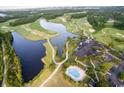 Aerial view of the golf course, clubhouse, pool, and lake in Grande Dunes, Myrtle Beach, SC at 2151 Bridgeview Ct. # 3-305, North Myrtle Beach, SC 29582