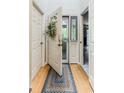 Bright entryway with an open door that has decorative wreath and leads to a glimpse of the outdoor porch at 220 Clubhouse Dr. # 20B, Sunset Beach, NC 28468