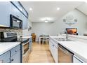 Stylish kitchen with stainless steel appliances, modern faucet, and a view to the adjacent dining area at 220 Clubhouse Dr. # 20B, Sunset Beach, NC 28468