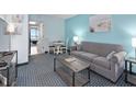 Inviting living room featuring a comfortable gray sofa, a dining area, and bright, airy decor at 2401 S Ocean Blvd. S # 1256, Myrtle Beach, SC 29577