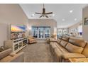 Spacious living room featuring a ceiling fan, comfortable seating, and a view into the kitchen at 254 Tall Palms Way, Little River, SC 29566