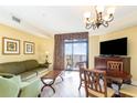 Comfortable living room with stylish furniture, including a sofa, chair, and balcony access at 2600 N Ocean Blvd. # 1401, Myrtle Beach, SC 29577