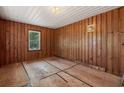 Bedroom featuring wood paneling, white ceiling, and a bright window at 2865 N Nichols Hwy., Nichols, SC 29581