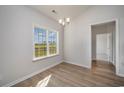 Cozy dining room with wood flooring and a view of the lush green yard at 3339 Little Bay Dr., Conway, SC 29526
