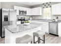 Modern kitchen featuring stainless steel appliances, granite countertops, and a spacious island with seating at 342 Myrtle Meadows Dr # 463F, Conway, SC 29526