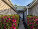 Landscaped walkway leading to front entrance with flowering bushes at 400 Woodpecker Ln. # 17B, Murrells Inlet, SC 29576