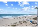 Expansive beach view with ocean waves and clear blue skies at 410 N Waccamaw Dr. # 306, Murrells Inlet, SC 29576