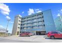 Multi-story condo building featuring covered parking and beach access at 410 N Waccamaw Dr. # 306, Murrells Inlet, SC 29576