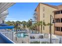Relaxing pool area with lounge chairs and well-maintained landscaping, ocean views at 5511 N Ocean Blvd. # 203, Myrtle Beach, SC 29577