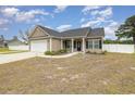 Cozy home with a well manicured lawn, an attached garage, and inviting entrance at 6392 Highway 378, Conway, SC 29527