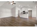 Bright, open-concept living space with vaulted ceilings, modern ceiling fan and wood-look flooring at 643 Snowy Owl Way, Conway, SC 29527