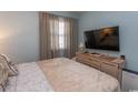 Bedroom with a large tv, bureau and soft, muted colors at 646 Tupelo Ln. # 4E, Longs, SC 29568