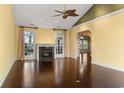 Bright living room featuring hardwood floors and a fireplace, with large windows bringing in lots of natural light at 808 East Coast Ln., North Myrtle Beach, SC 29582