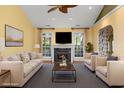 Cozy living room with a fireplace, comfortable seating, and large windows offering lots of natural light at 808 East Coast Ln., North Myrtle Beach, SC 29582