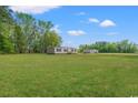A charming single story house with a lush green lawn and a backdrop of mature trees under a blue sky at 814 S Midway Hwy., Johnsonville, SC 29555