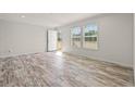 Bright, airy living room featuring wood-look floors, modern fixtures, and natural light with a neutral color palette at 814 S Midway Hwy., Johnsonville, SC 29555