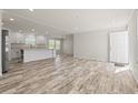 Open-concept living space featuring wood-look floors and access to the kitchen at 820 S Midway Hwy., Johnsonville, SC 29555